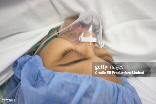 close up of hispanic woman under anesthesia - breathing device stock pictures, royalty-free photos & images