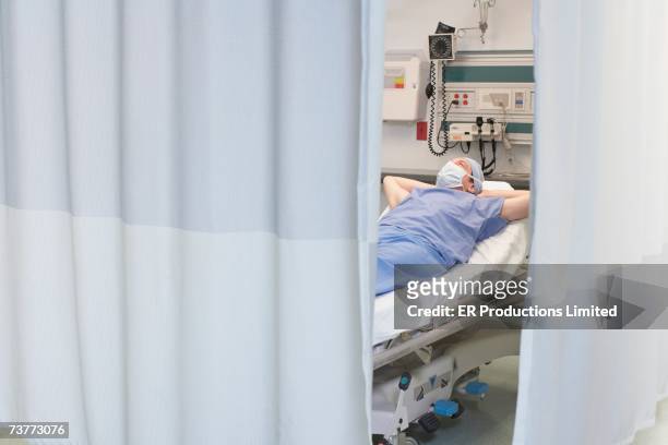 doctor sleeping in hospital bed - hospital curtain stock pictures, royalty-free photos & images