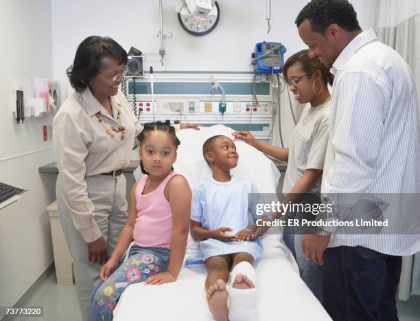 family visiting african boy with broken leg in hospital - er visit stock pictures, royalty-free photos & images