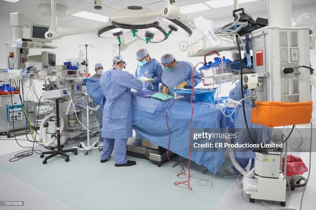 Surgeons performing surgery in operating room