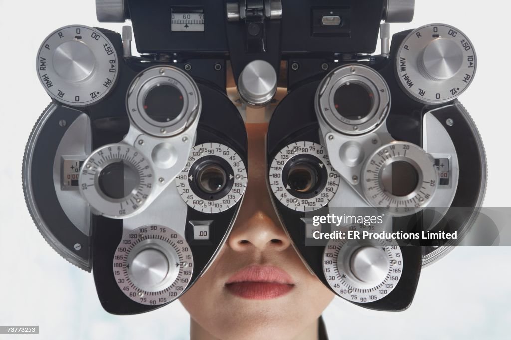 Woman's face behind ophthalmology equipment