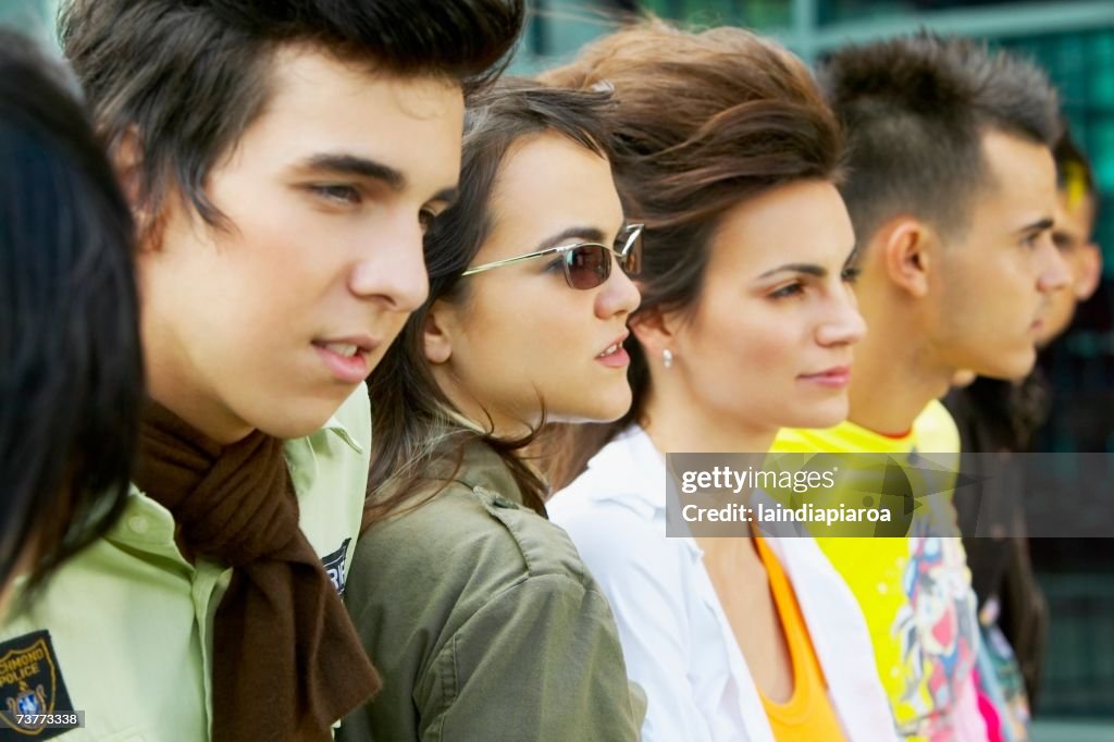 Group of Hispanic young people in a row outdoors