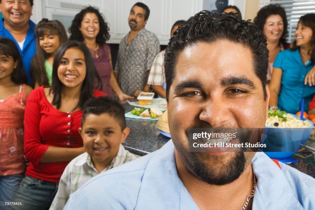Large Hispanic family in kitchen with food