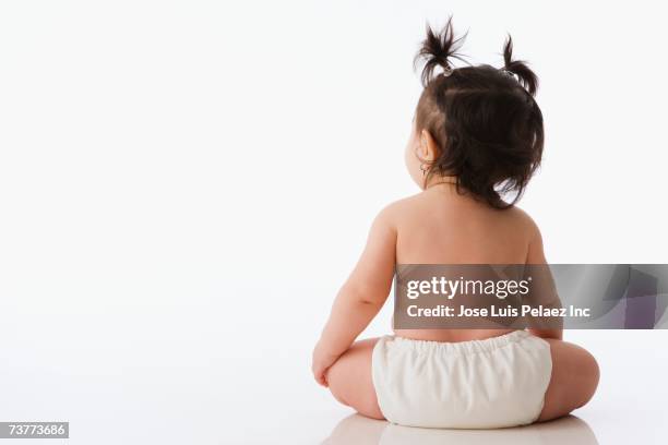 rear view studio shot of baby with pony tails - diaper girl stock pictures, royalty-free photos & images