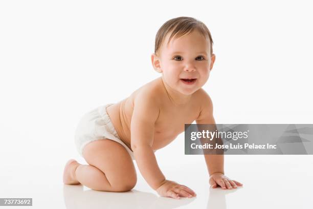 studio shot of baby crawling - crawling stock pictures, royalty-free photos & images