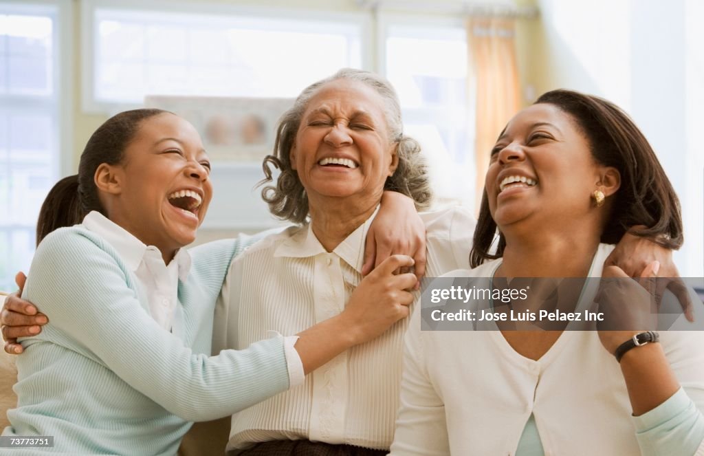 Three generations of African women laughing