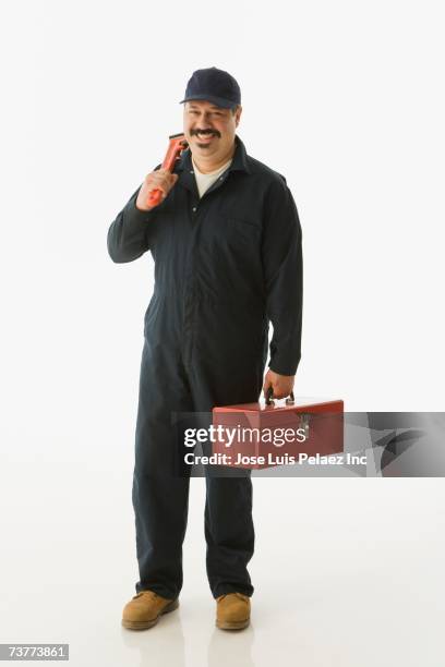 studio shot of hispanic handyman - plumber man stockfoto's en -beelden