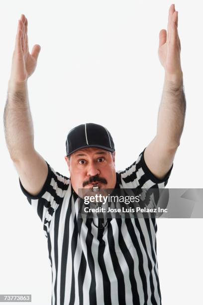 studio shot of hispanic male referee making a call - sportdomare bildbanksfoton och bilder