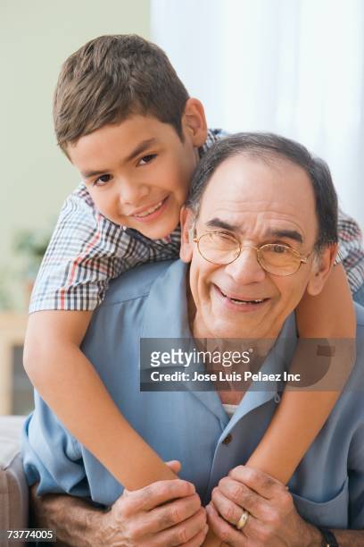 hispanic grandfather and grandson hugging - puerto rican ethnicity stockfoto's en -beelden
