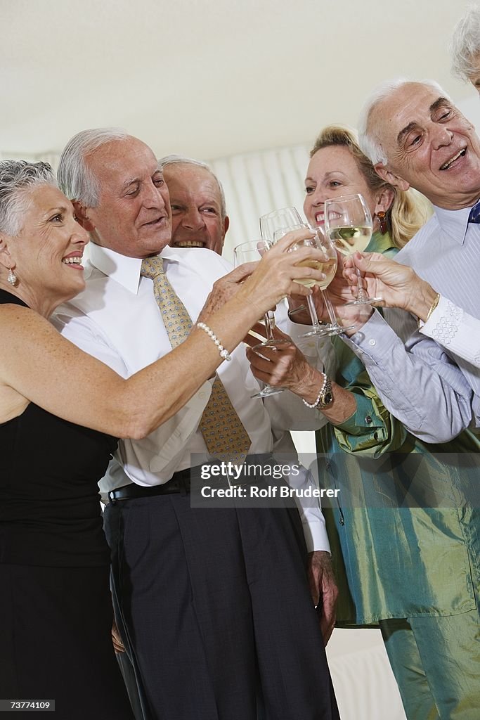 Senior couples toasting at party