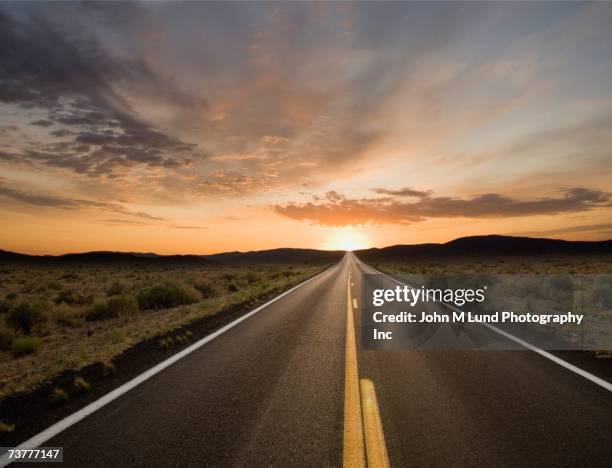 remote road at dusk - arizona sunset stock pictures, royalty-free photos & images