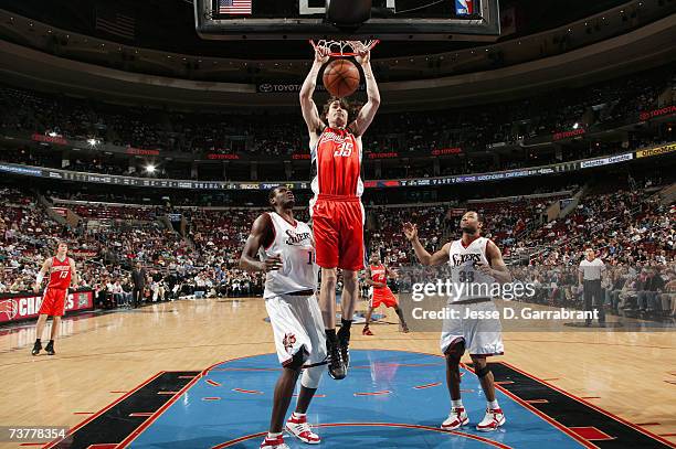 Adam Morrison of the Charlotte Bobcats slam dunks over Samuel Dalembert and Willie Green of the Philadelphia 76ers during the game at the Wachovia...