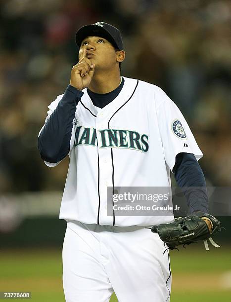 Starting Pitcher Felix Hernandez of the Seattle Mariners points to the sky after recording the third out of the eighth inning against the Oakland A's...