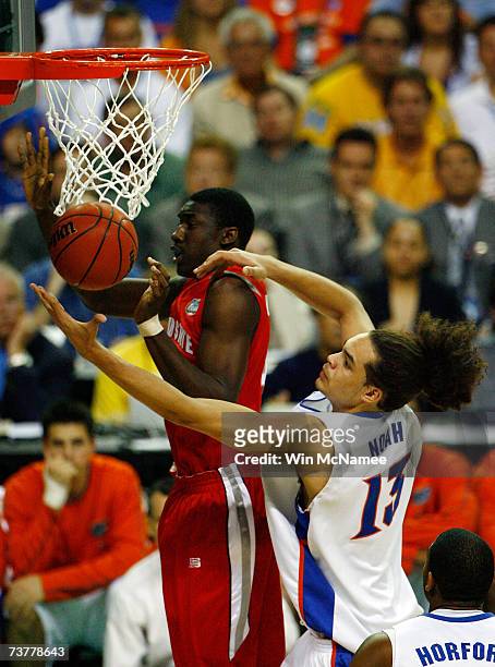 Joakim Noah of the Florida Gators fights for a for a rebound with Mike Conley Jr. #1 of the Ohio State Buckeyes in the NCAA Men's Basketball...