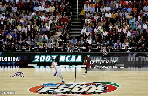 Mike Conley Jr. #1 of the Ohio State Buckeyes takes the ball upcourt against the Florida Gators in the NCAA Men's Basketball Championship game at the...