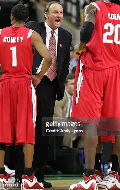Head coach Thad Matta of the Ohio State Buckeyes speaks to Greg Oden and Mike Conley Jr. #1 during a break in play against the Florida Gators in the...