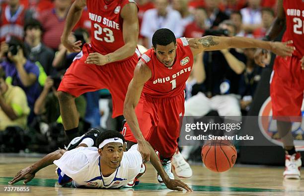 Corey Brewer of the Florida Gators fights for a loose ball against Mike Conley Jr. #1 of the Ohio State Buckeyes during the NCAA Men's Basketball...
