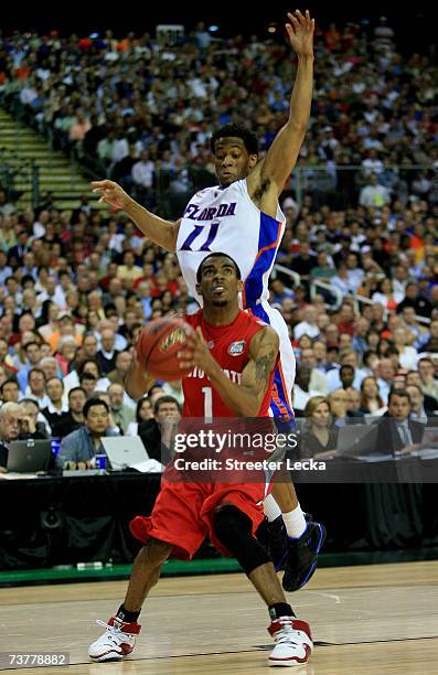 Mike Conley Jr. #1 of the Ohio State Buckeyes looks to shoot against Taurean Green of the Florida Gators in the NCAA Men's Basketball Championship...