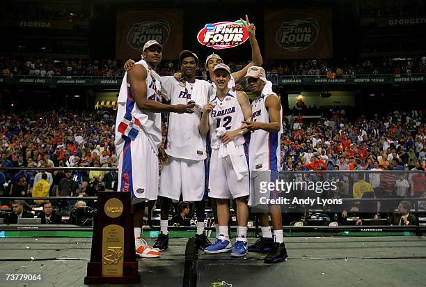 Al Horford, Taurean Green, Joakim Noah, Lee Humphrey and Corey Brewer of the Florida Gators celerate after defeating the Ohio State Buckeyes during...