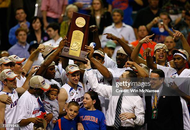 Head coach Billy Donovan and his Florida Gators celebrate with the trophy after defeating the Ohio State Buckeyes during the NCAA Men's Basketball...