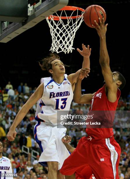 Joakim Noah of the Florida Gators fights for a rebound with Mike Conley Jr of the Ohio State Buckeyes during the NCAA Men's Basketball Championship...