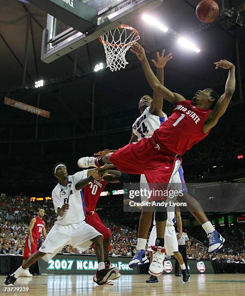 Mike Conley Jr. #1 of the Ohio State Buckeyes goes to the hoop against Marreese Speights of the Florida Gators in the NCAA Men's Basketball...