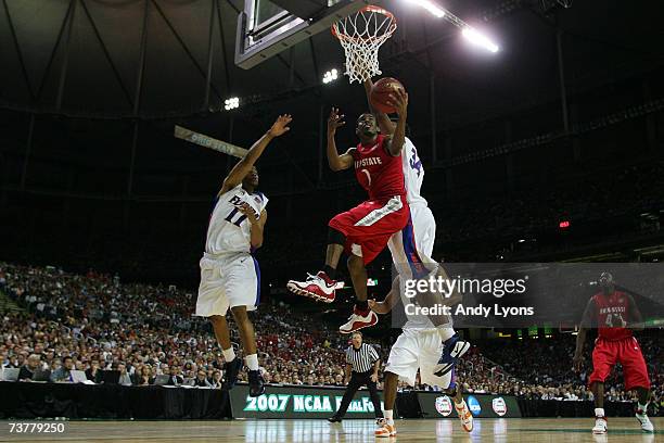 Mike Conley Jr. #1 of the Ohio State Buckeyes goes to the hoop against Marreese Speights of the Florida Gators in the NCAA Men's Basketball...