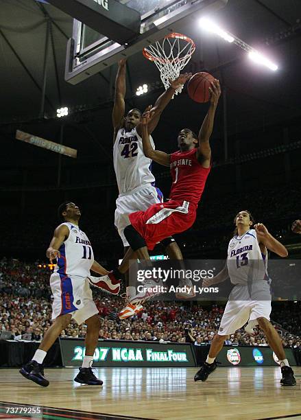 Mike Conley Jr. #1 of the Ohio State Buckeyes goes to the hoop against Al Horford the Florida Gators in the NCAA Men's Basketball Championship game...