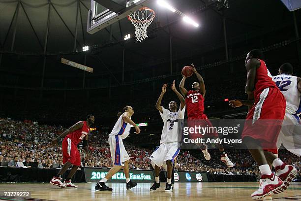 Lee Humphrey of the Ohio State Buckeyes goes to the hoop against Corey Brewer of the Florida Gators in the NCAA Men's Basketball Championship game at...
