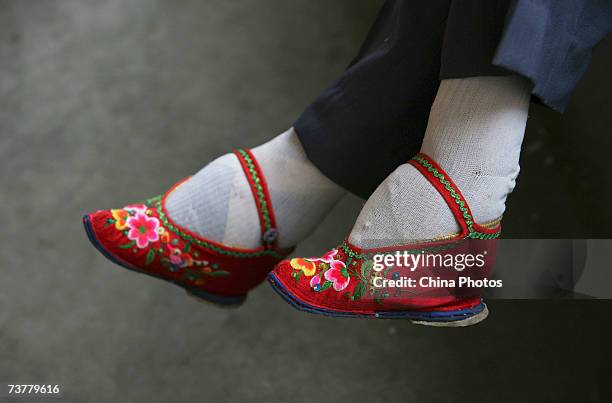 Member of the Bound Feet Women Dancing Team, wearing her "Three Cuns Golden Lotus" shoes, prepares for dancing practice at Liuyi Village on April 2,...