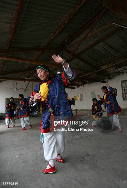 Year-old Xiao Xiuxiang, member of the Bound Feet Women Dancing Team, practises dancing at Liuyi Village on April 2, 2007 in Tonghai County of Yunnan...