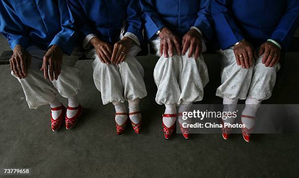 Members of the Bound Feet Women Dancing Team, pose for pictures during dancing practice at Liuyi Village on April 2, 2007 in Tonghai County of Yunnan...