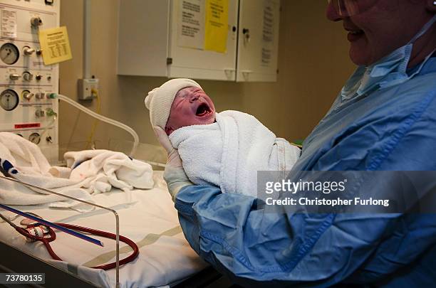 In this file photograph dated March 6 a young boy is weighed after being born in an NHS maternity unit, in Manchester, England. Health Secretary...