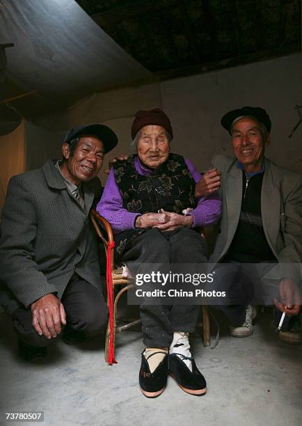 Year-old bound feet woman, whose surname is Luo Pu, poses for pictures with her son at Liuyi Village on April 3, 2007 in Tonghai County of Yunnan...