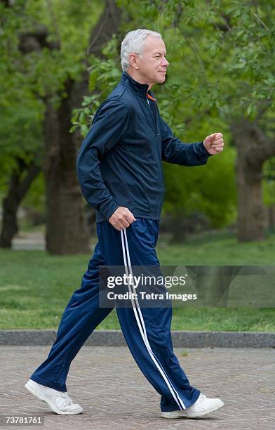 senior man power walking - power walking stock pictures, royalty-free photos & images