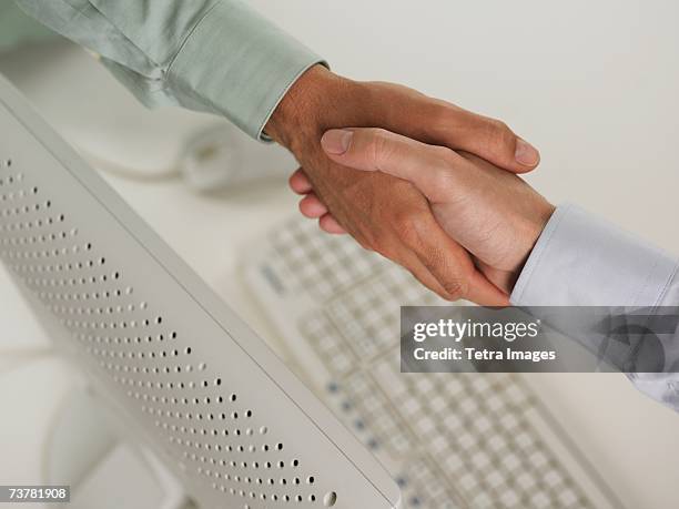 Hand Shaking Computer 87 Shaking Hands Over Desk Stock Photos, High-Res Pictures, and Images ...