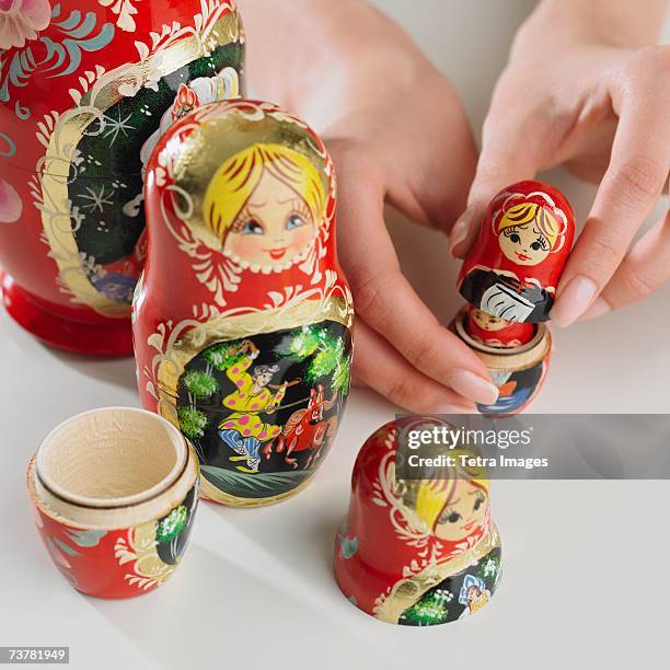 close up of woman's hand with nesting dolls - novelty item stock pictures, royalty-free photos & images