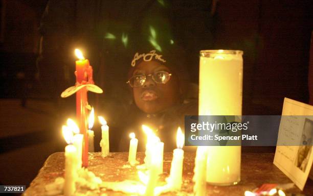 Justin Sarkodie attends a candlelight vigil for Amadou Diallo February 4, 2001 in the Bronx borough of New York City beside the doorway where the...