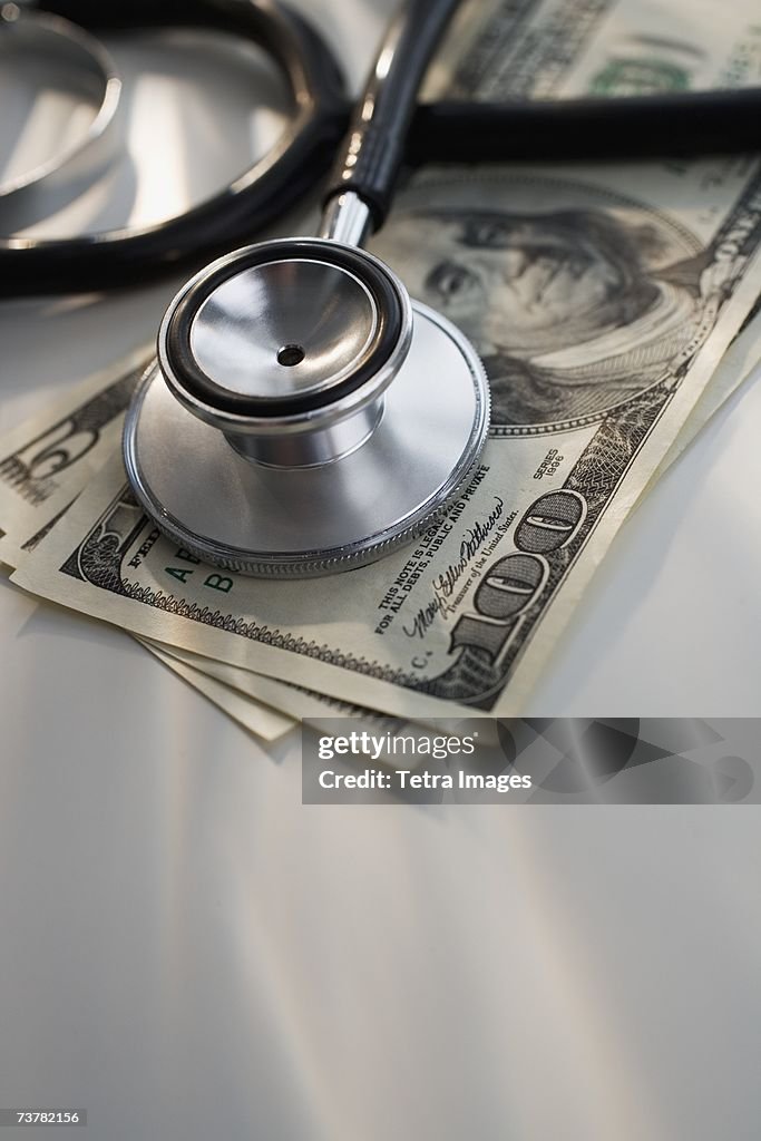 Close up of stethoscope and US dollars