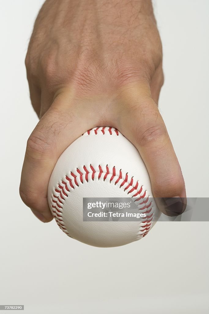 Close up of pitcher holding baseball