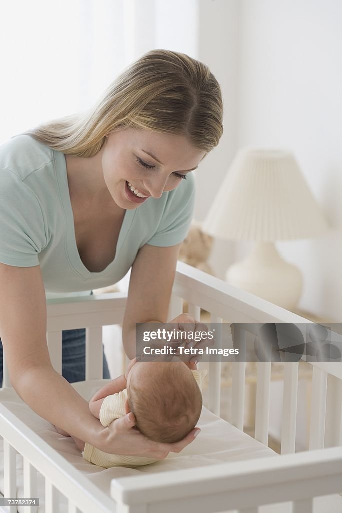 Mother smiling at newborn baby