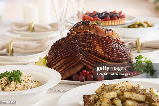 spiral ham and side dishes on set table - spiral ham stock pictures, royalty-free photos & images