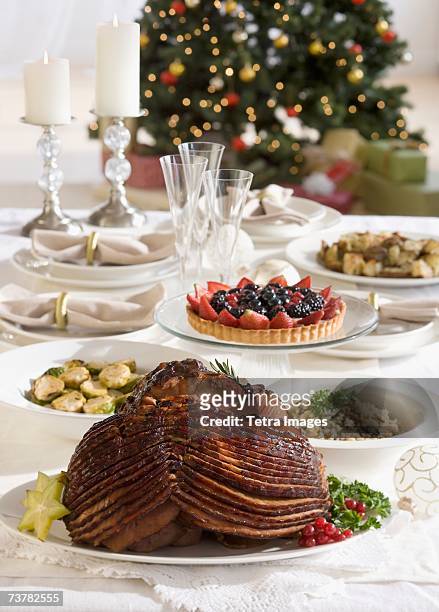 spiral ham and side dishes on christmas table - spiral ham stock pictures, royalty-free photos & images