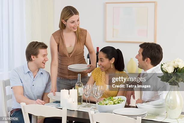 two couples having dinner party - couple hosting dinner stock pictures, royalty-free photos & images