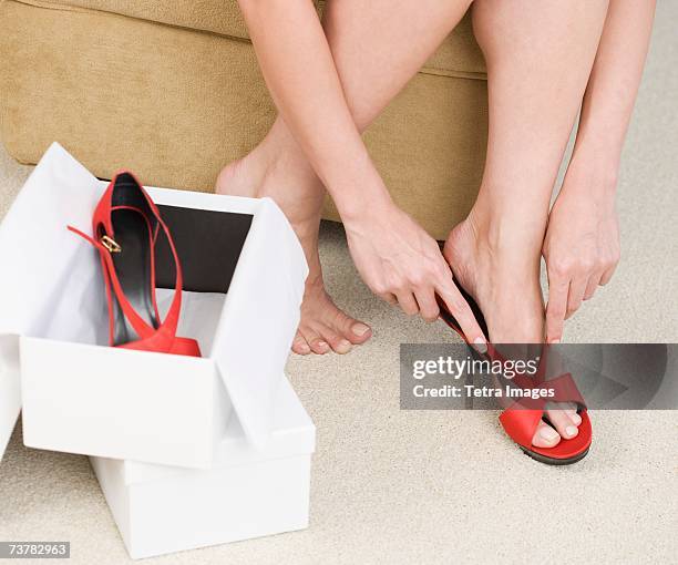 Close Up Of Woman Trying On Shoes, Photo