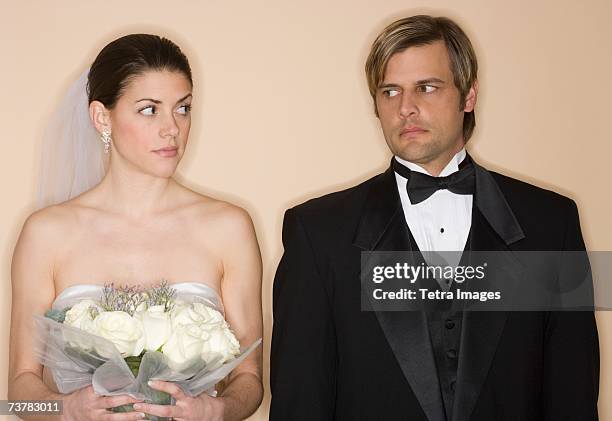 angry bride and groom looking at each other - bridegroom stock pictures, royalty-free photos & images