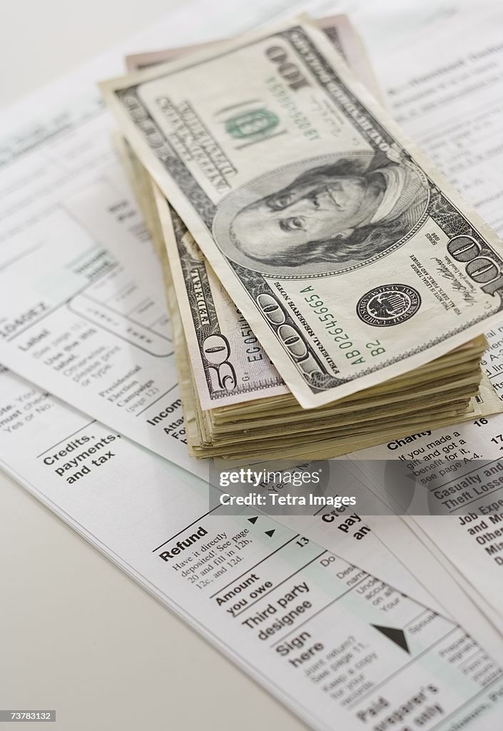 Stack of money on tax forms