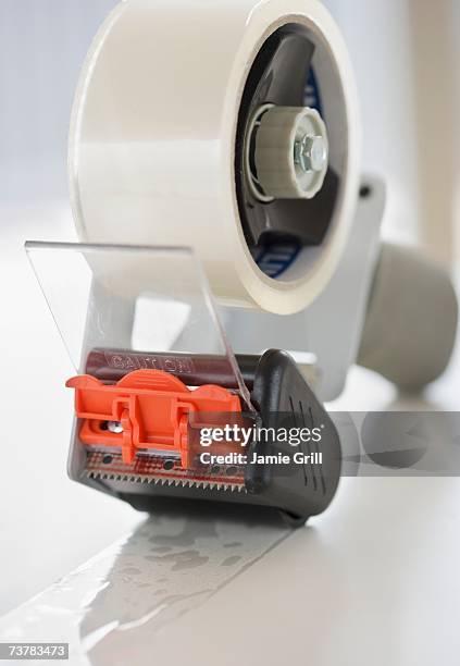 close up of packing tape - tape dispenser stock-fotos und bilder