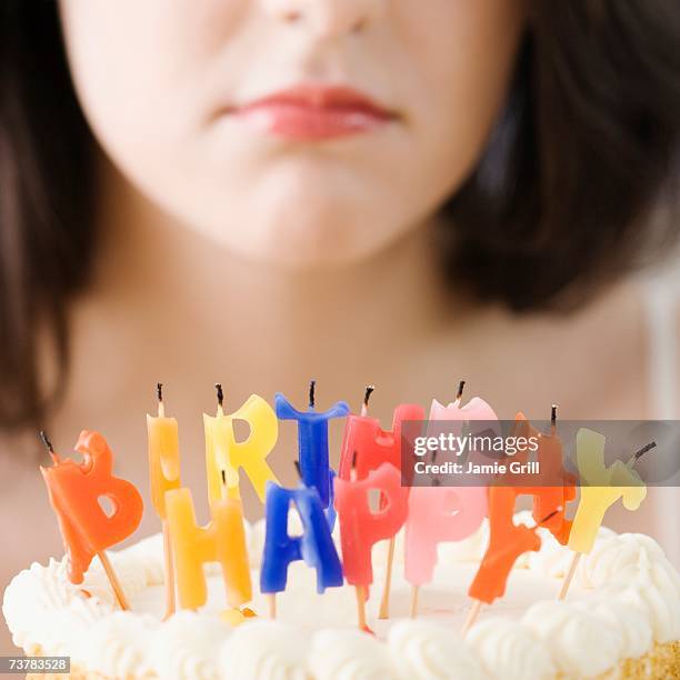 woman frowning at blown out birthday candles - sad birthday stock pictures, royalty-free photos & images