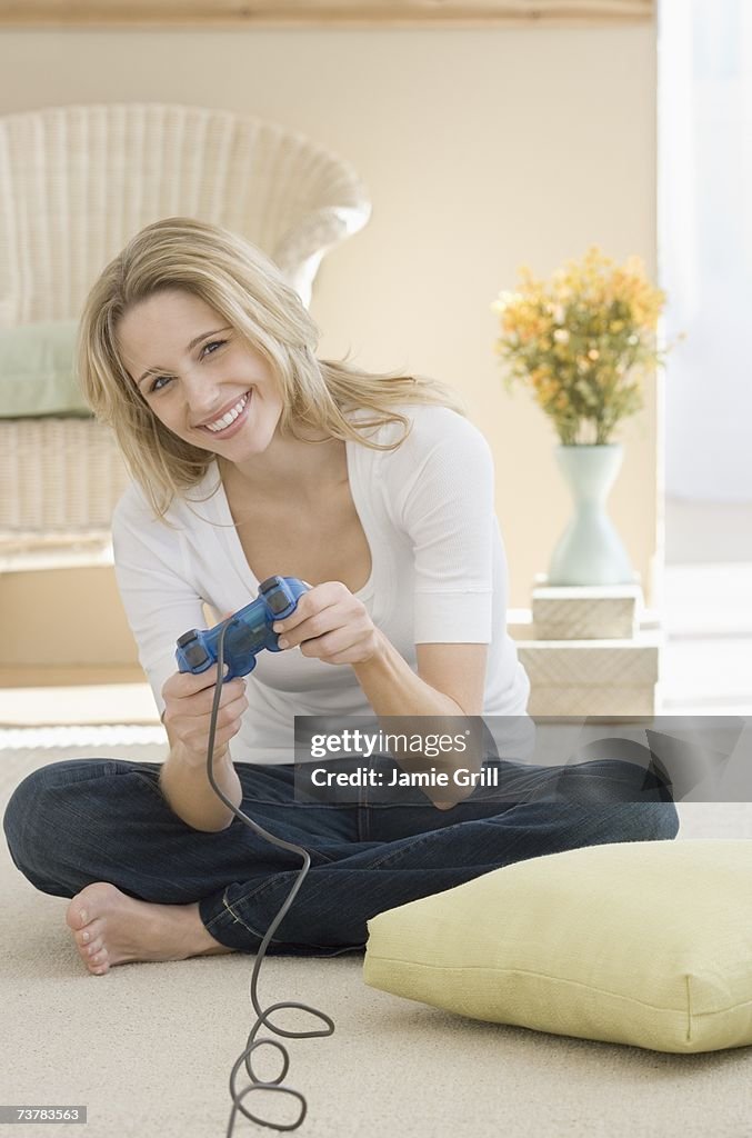 Woman playing video games on floor